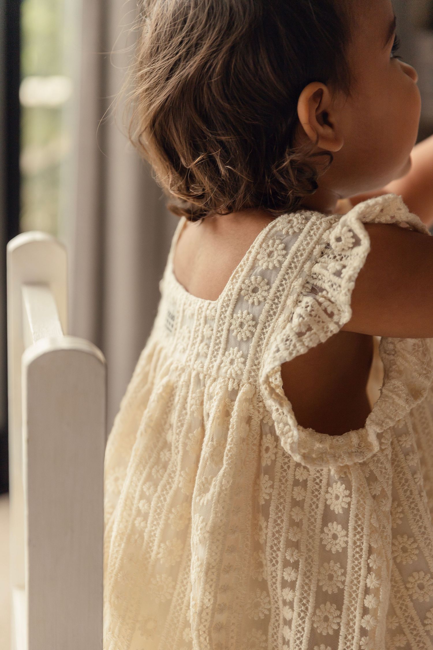 A woman wearing a vintage-style cream lace blouse with high collar shown from multiple angles in soft natural light.
