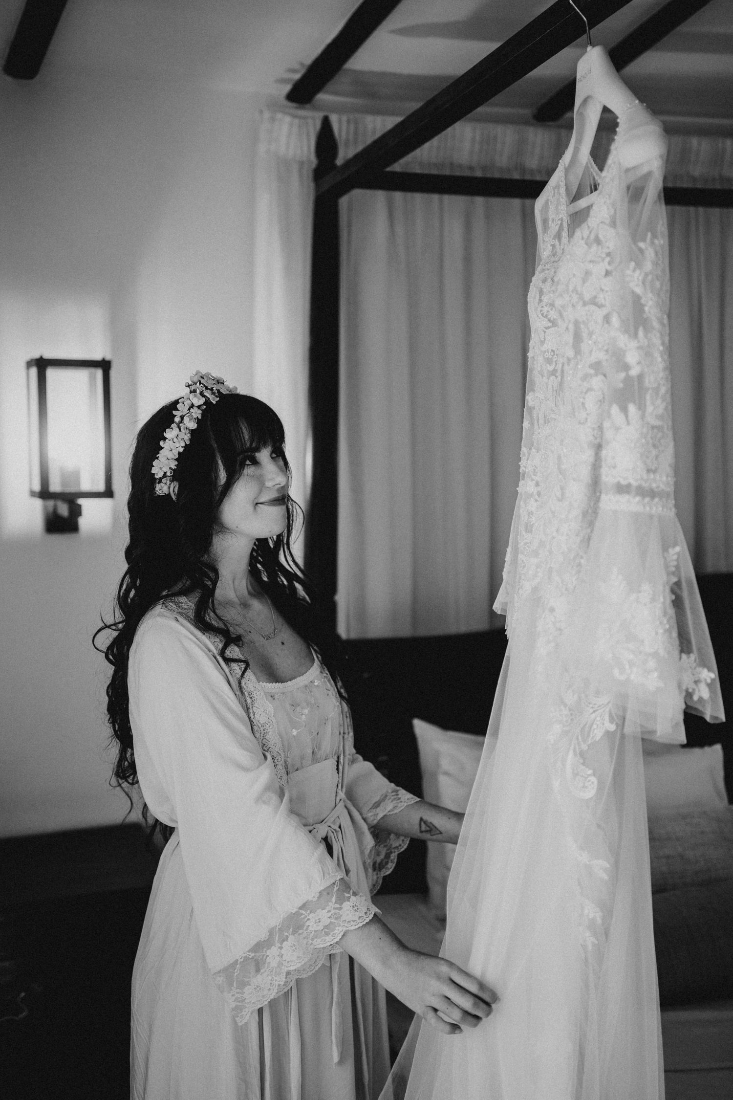 A tender black and white silhouette of wedding preparation by a window.