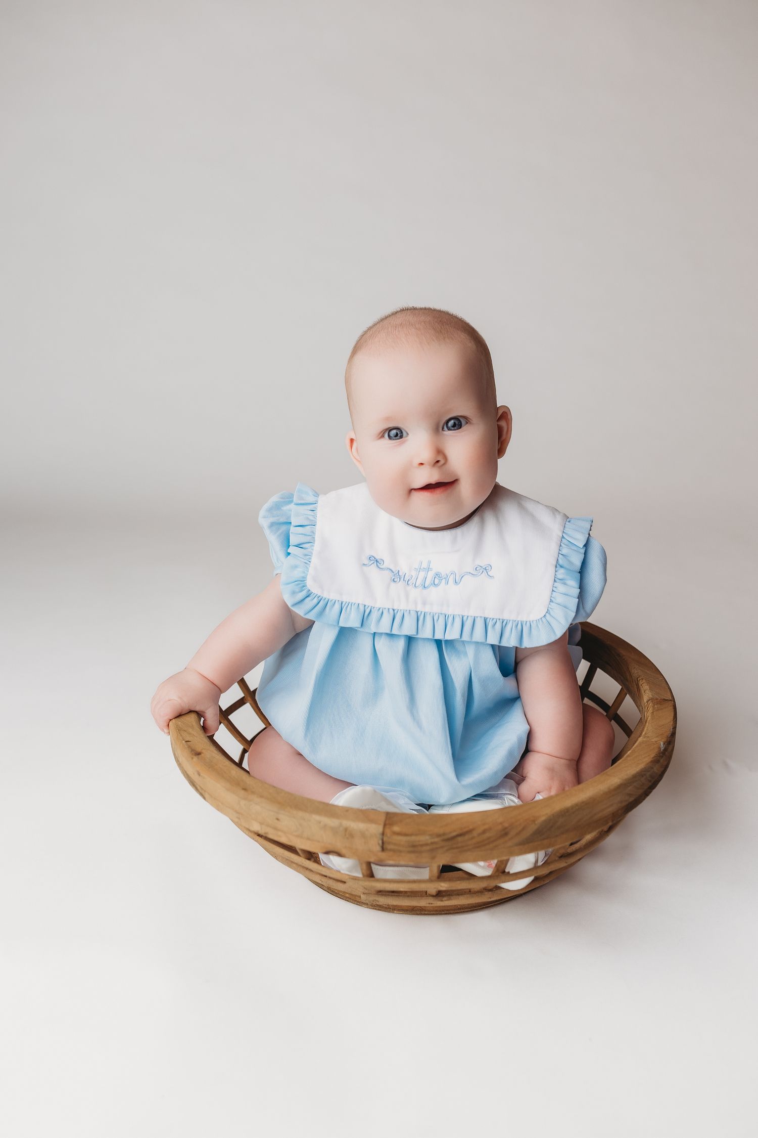 smiling six month old girl during heirloom session