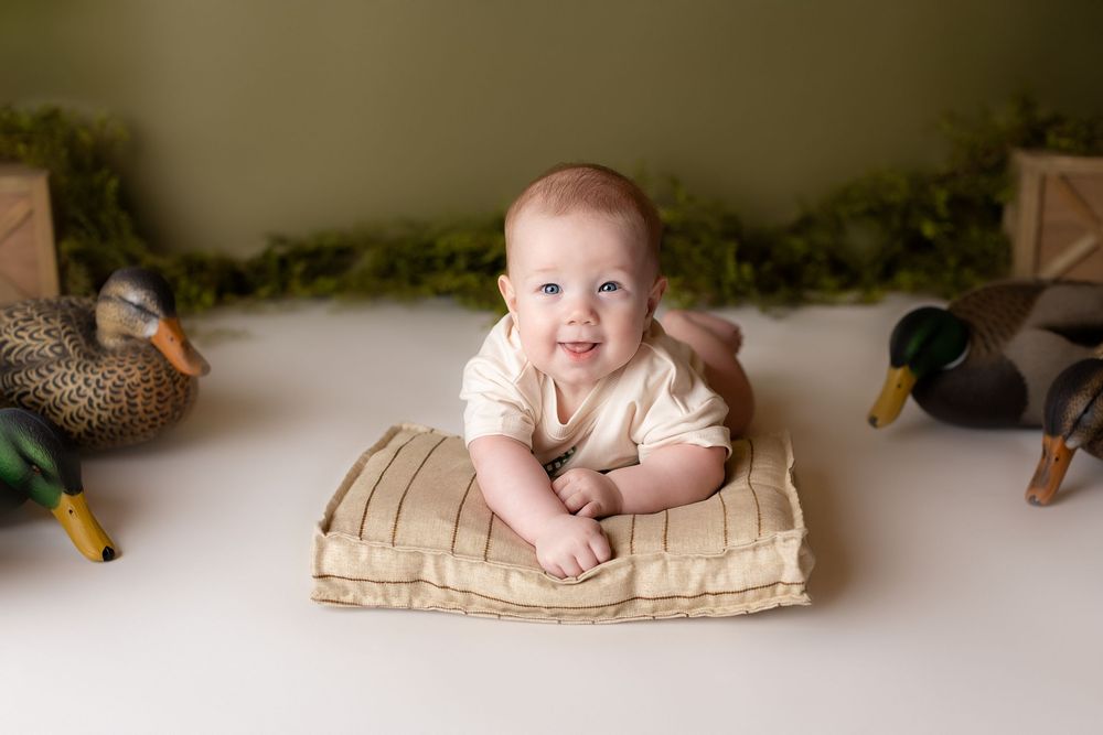 duck calls and duck decoys around a 6 month old boy for his 1/2 year photoshoot