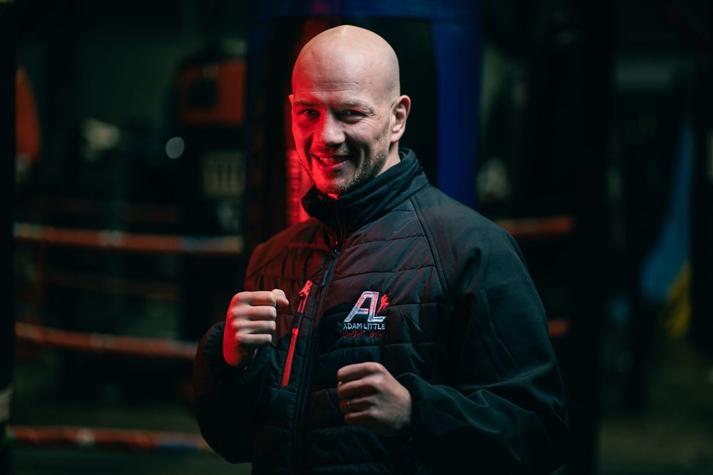Athletes or trainers in black hoodies are shown in a series of darkly lit shots during what appears to be training.