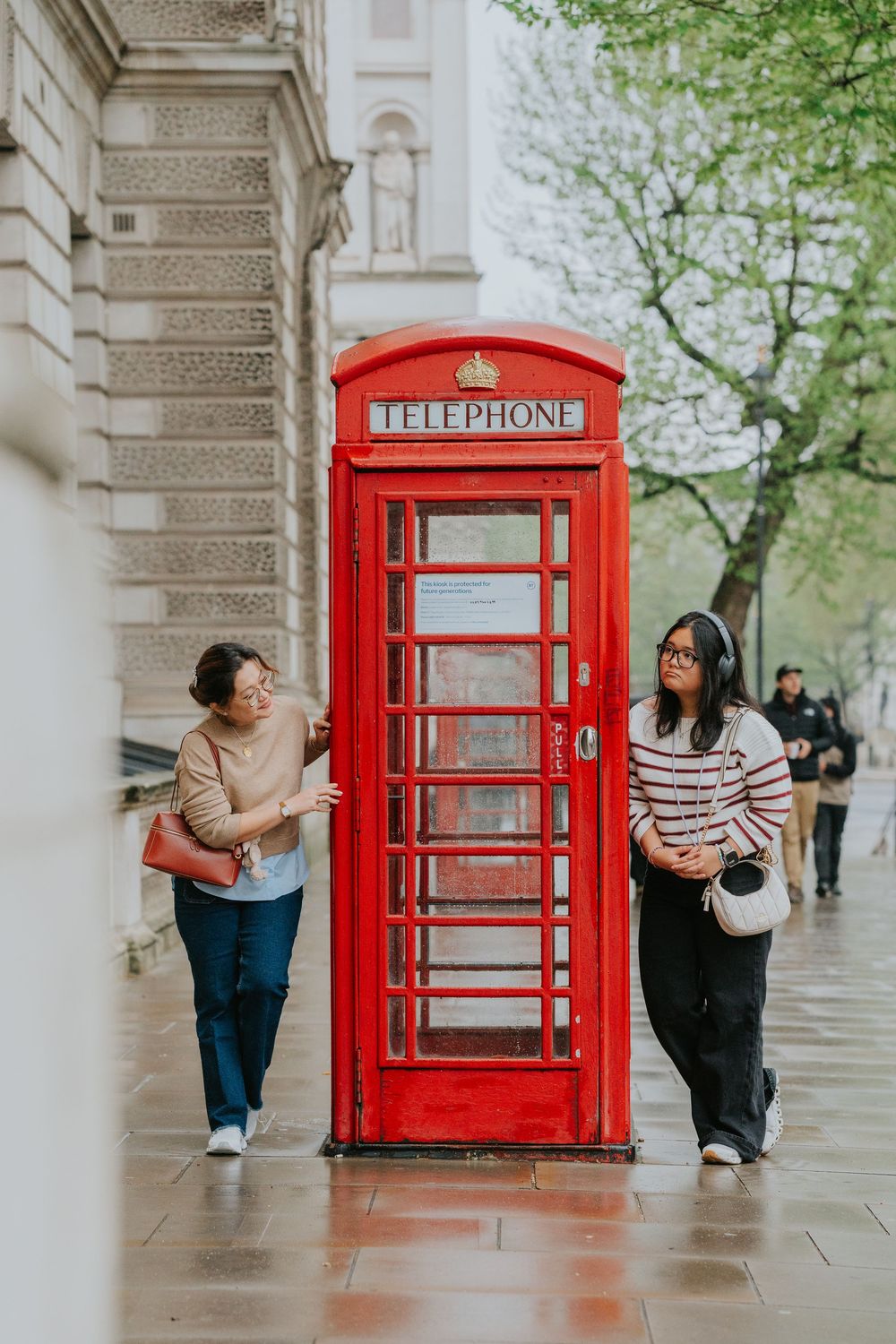 A series of artistic photos showing different poses with a classic red British phone booth in London.