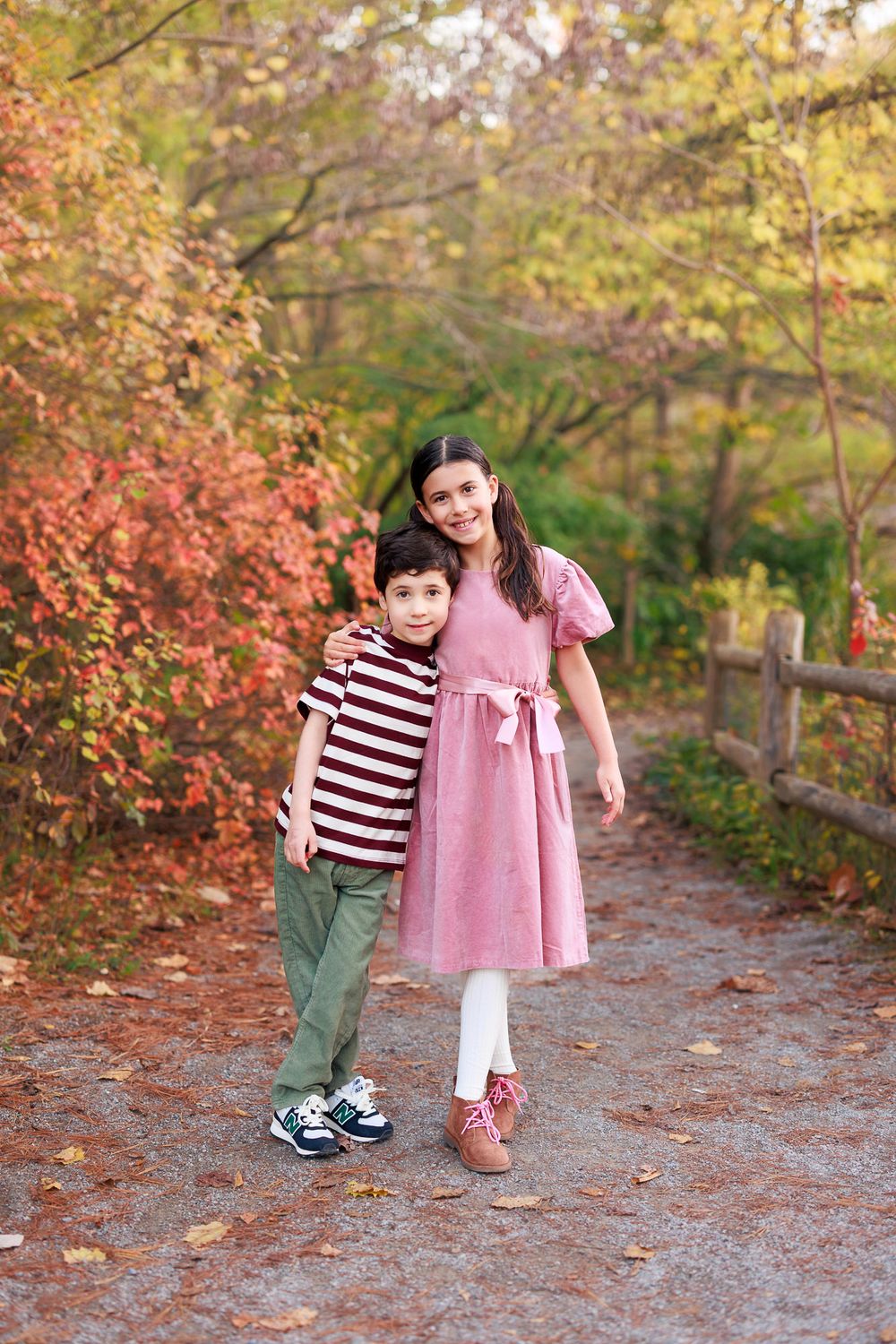 Sibling portrait of two children walking together during a fall family session in Toronto