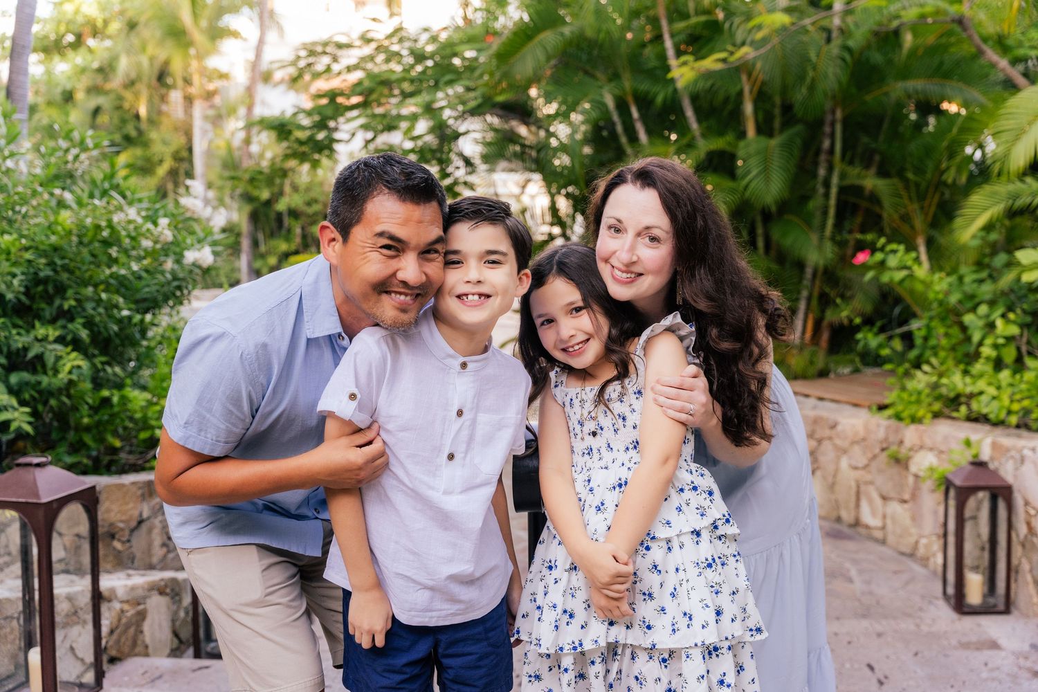 Joyful family moment captured on a sandy beach during golden hour.