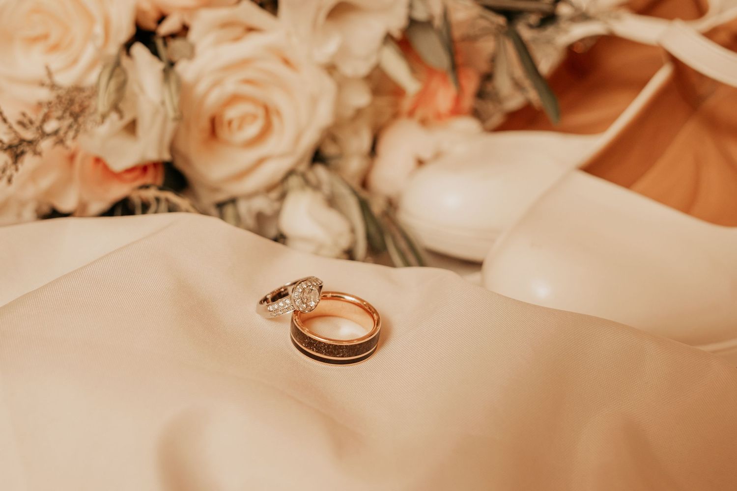 wedding rings and flowers on a wedding dress