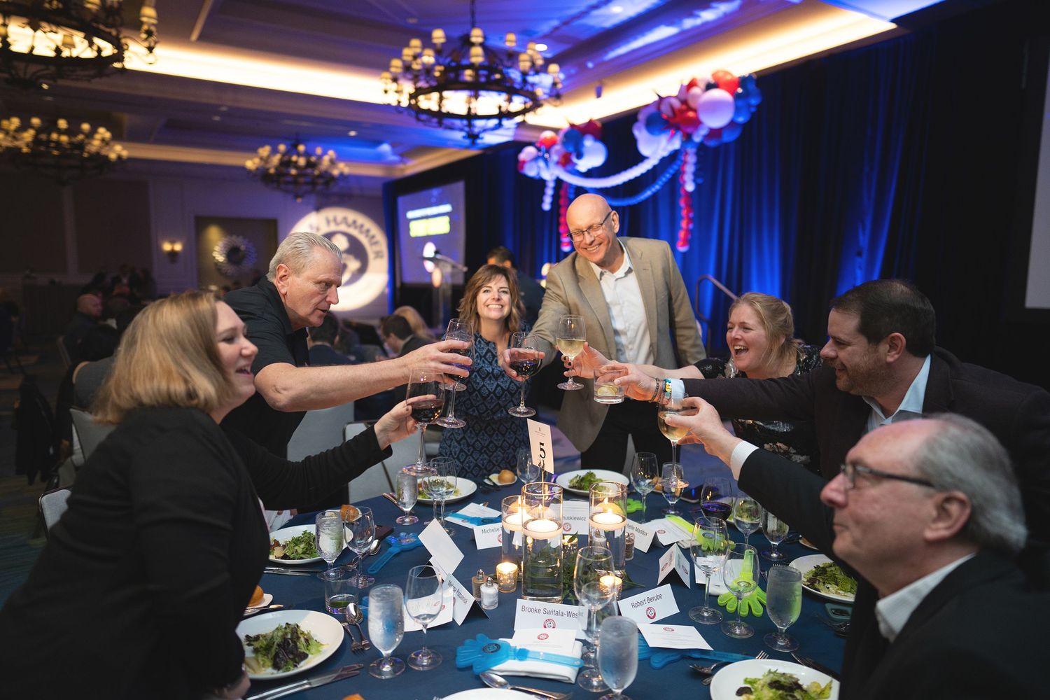 Orlando corporate event photographer Ray Alvarez — corporate gala dinner reception coverage with guests toasting at event