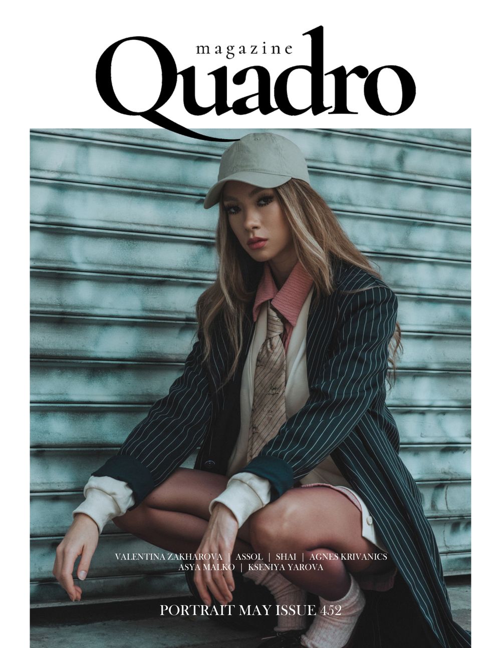 Fashion magazine cover featuring sophisticated pinstripe suit styling against turquoise backdrop.