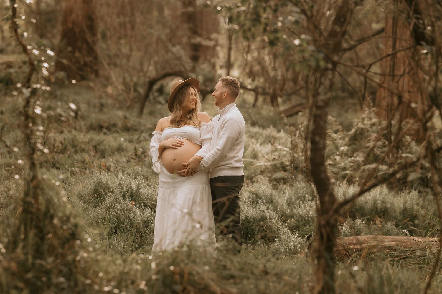 Intimate woodland wedding portraits with warm autumn colors and natural scenery.