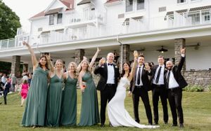 Wedding party celebrate joyfully on the lawn of a Windermere House in Muskoka- Alexis Anne Photography