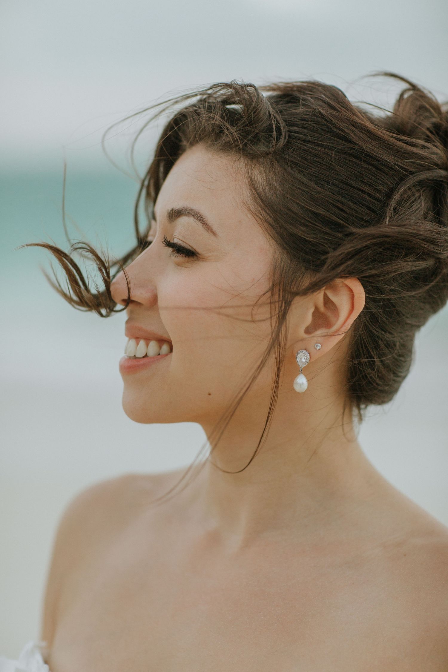 Side profile portrait series showing joyful expressions and delicate pearl earrings against a soft neutral background.
