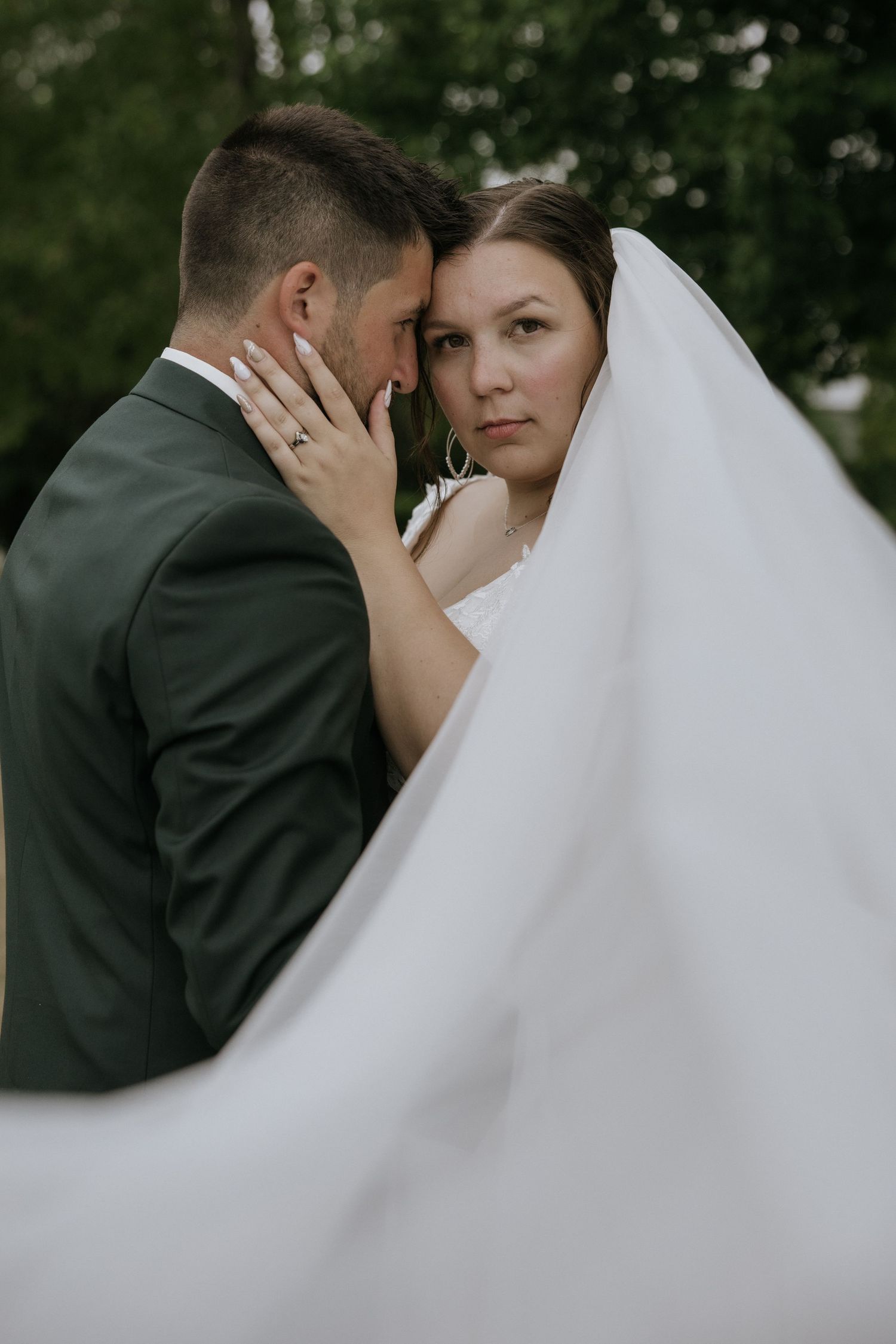 A series of intimate wedding photos showing tender moments between newlyweds with a flowing white veil.