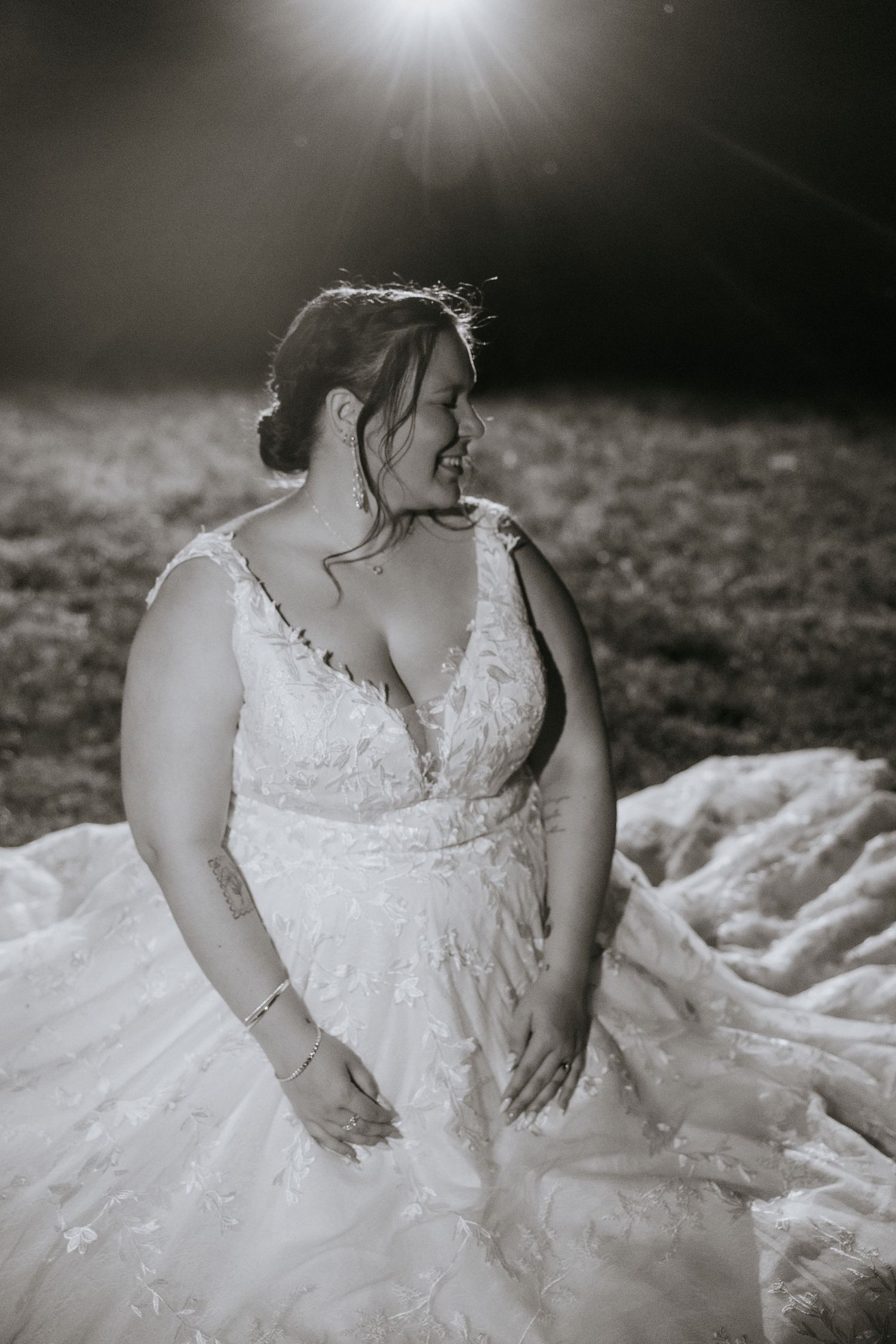 Black and white bridal portraits showing the intricate details of a lace wedding dress in dramatic lighting.
