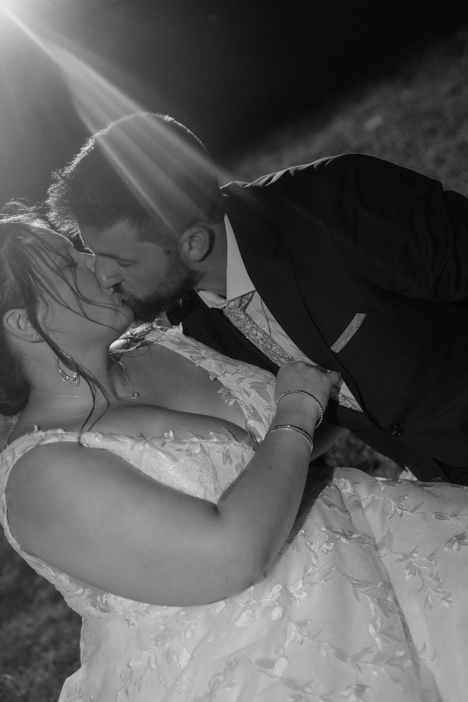 A romantic black and white wedding photo sequence showing a couple in formal attire sharing an intimate moment.