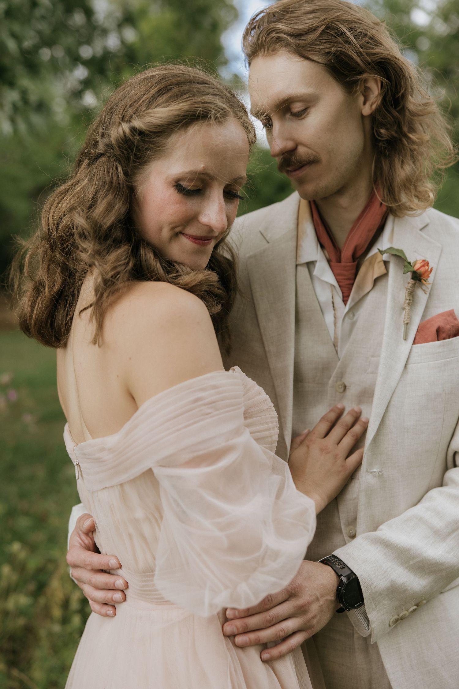 A romantic outdoor wedding photo series showing tender moments between a couple in light colored attire.