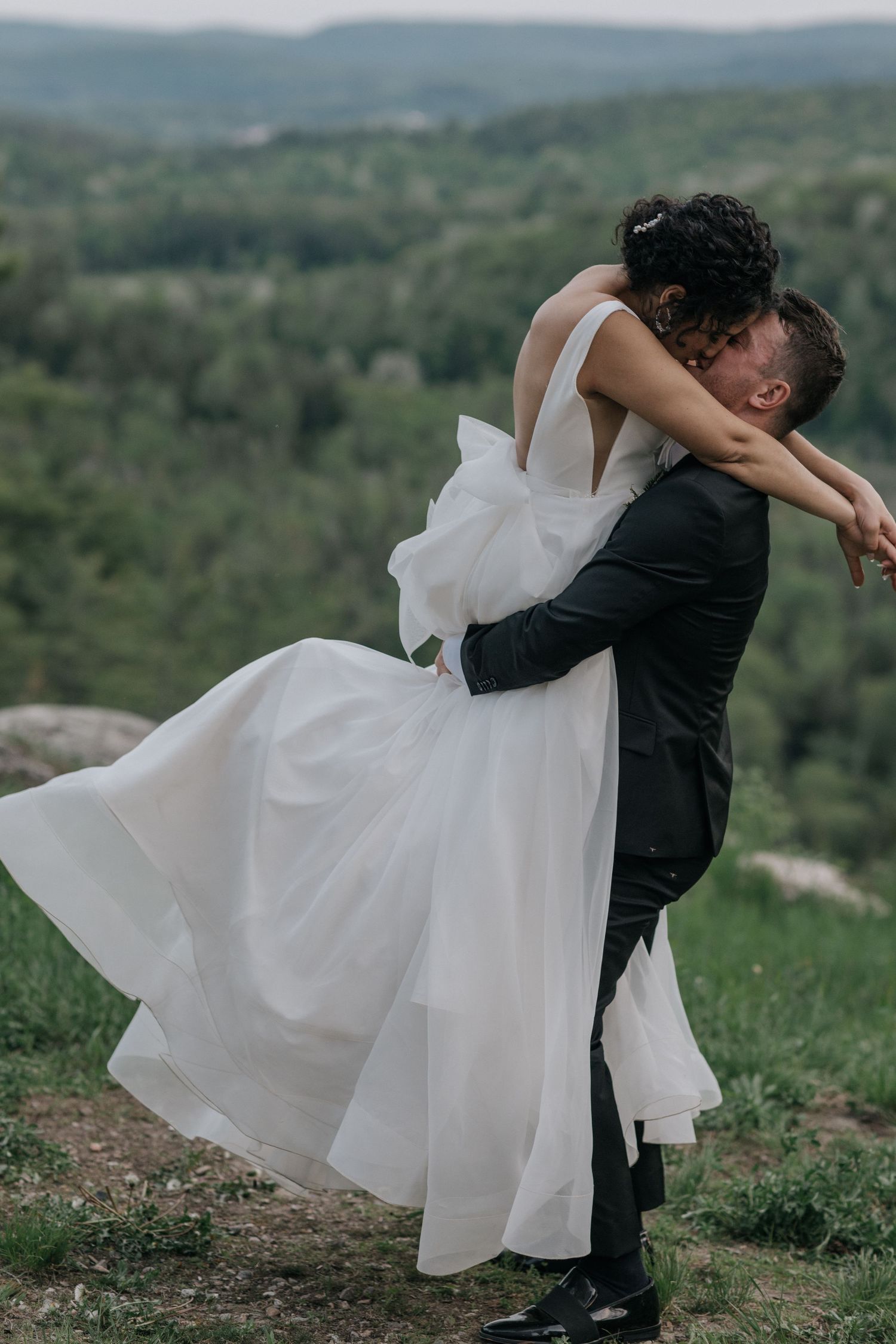 Couple shares intimate dancing moments against a beautiful mountain vista.
