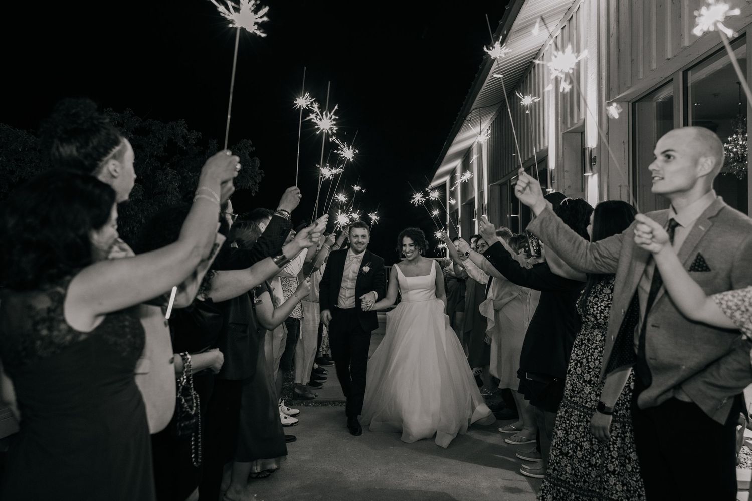Wedding reception party with sparklers creating magical nighttime celebration atmosphere.