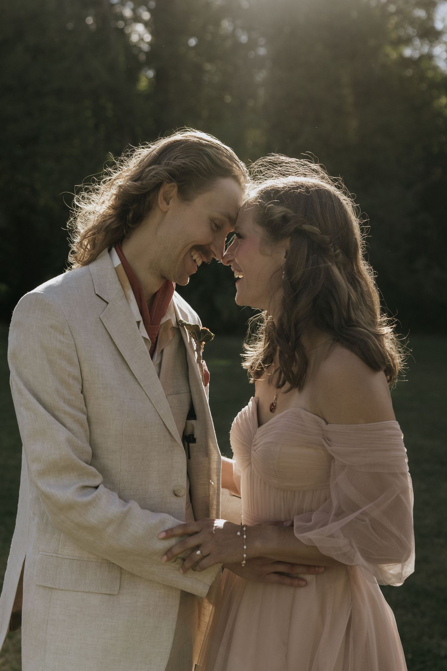 A romantic couple in white outfits share tender moments in a sunlit outdoor setting across four similar photos.