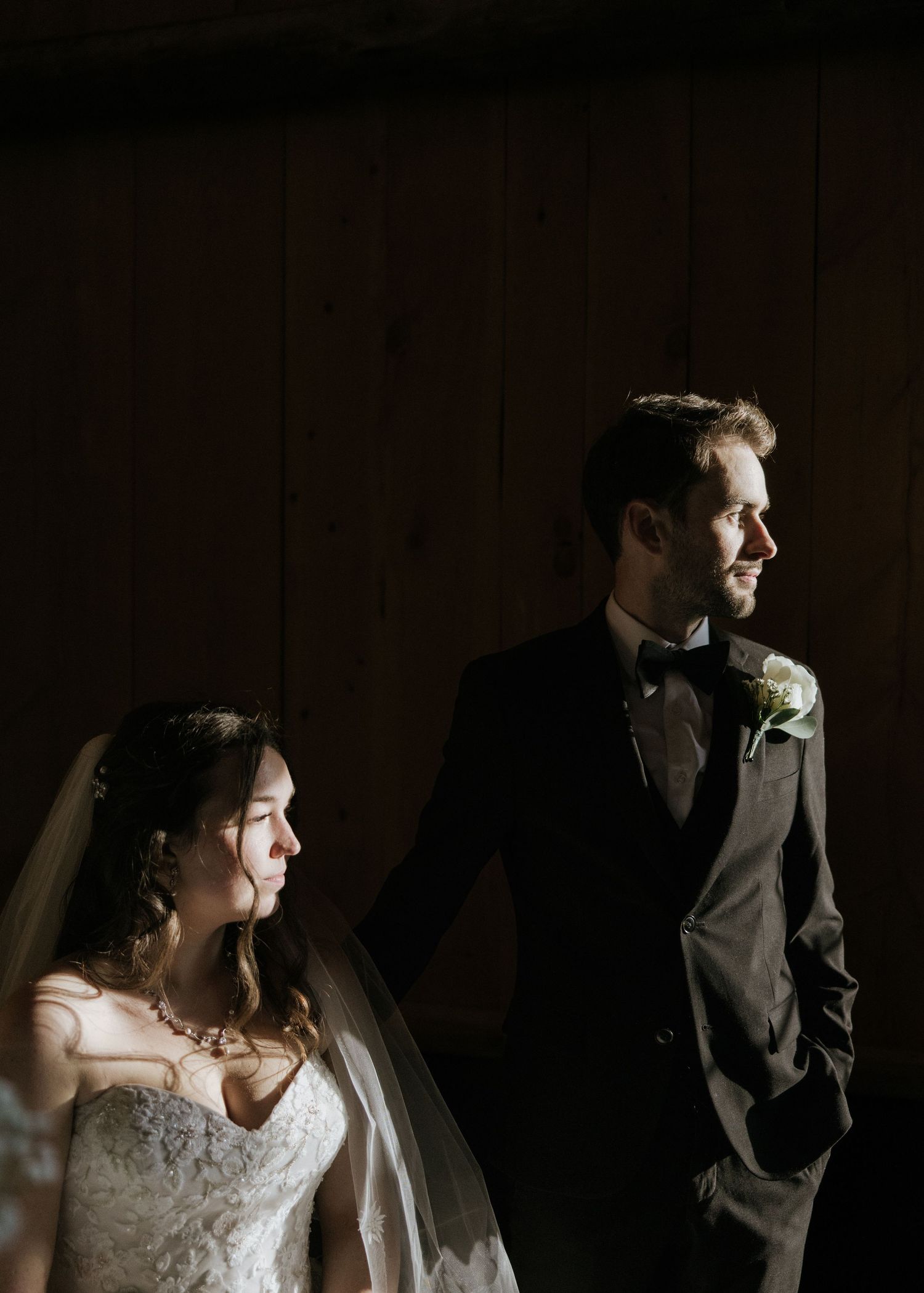 A wedding couple poses in a dramatic series of black and white portraits showing intimate moments and emotions.