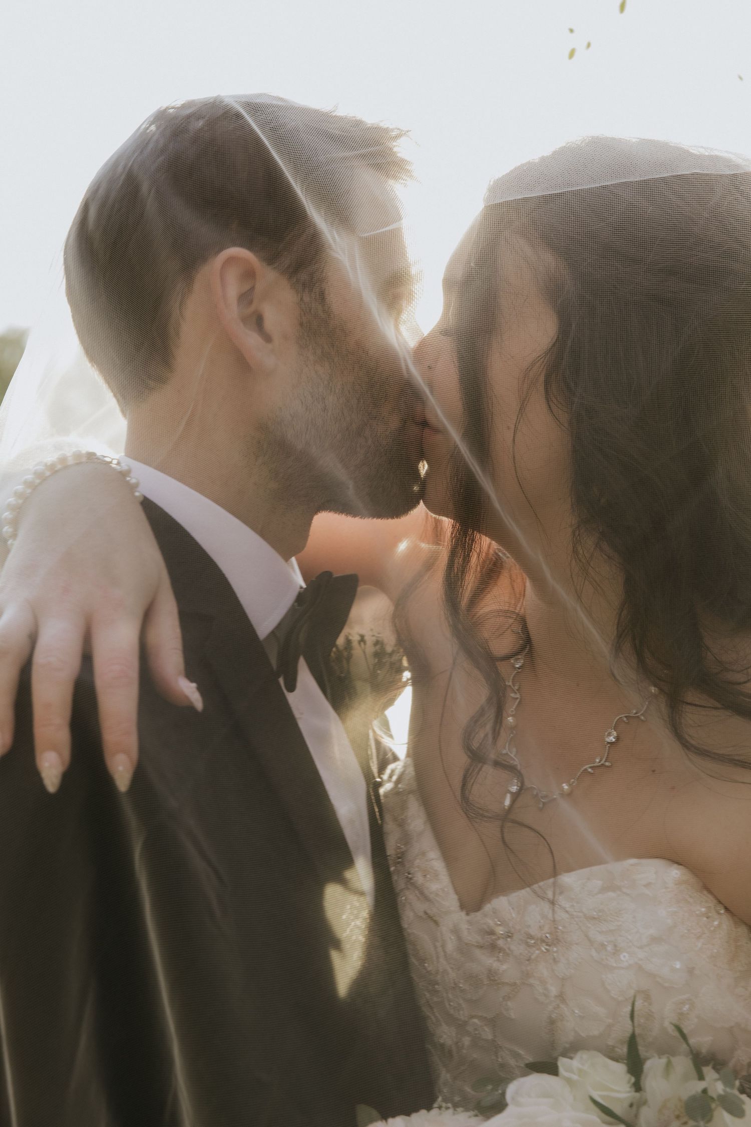 A romantic sequence of wedding photos showing a couple in formal attire sharing intimate moments at sunset.