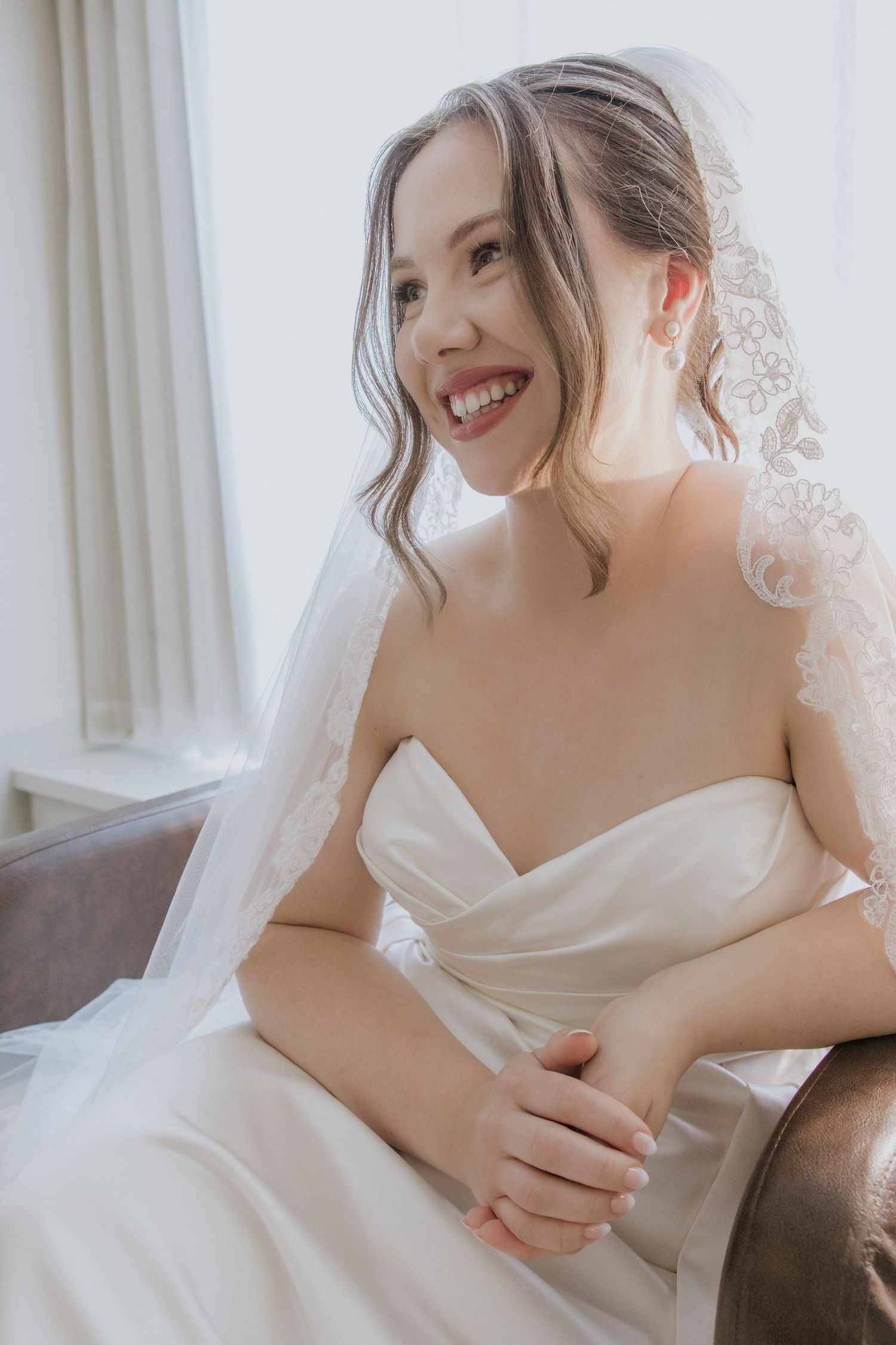 A series of intimate bridal portraits showing a white wedding dress and delicate veil against a light background.