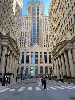 Tall art deco office building in Chicago's financial district viewed from street level with ornate stone columns.