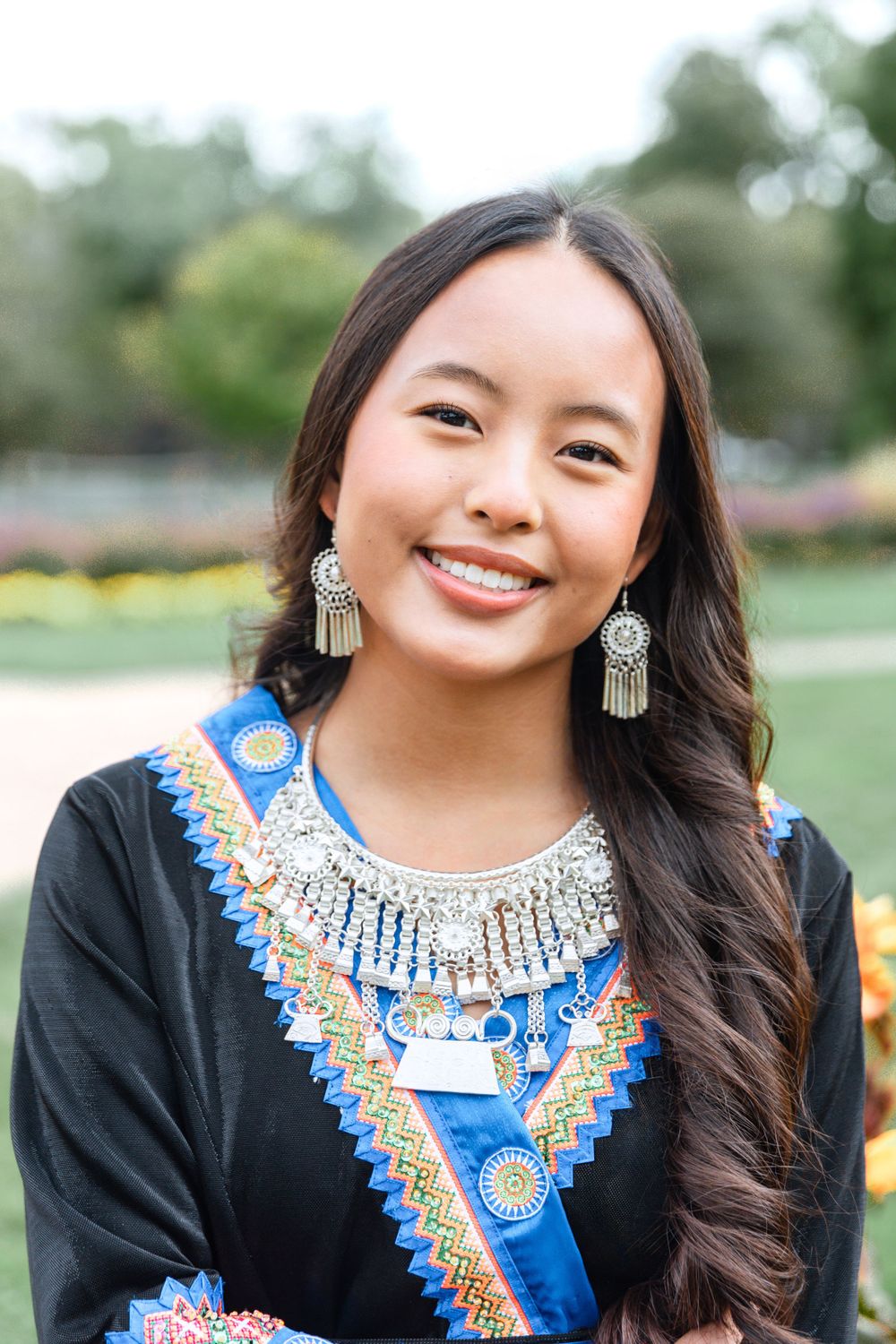 Girl smiling in her culture clothes in the garden.