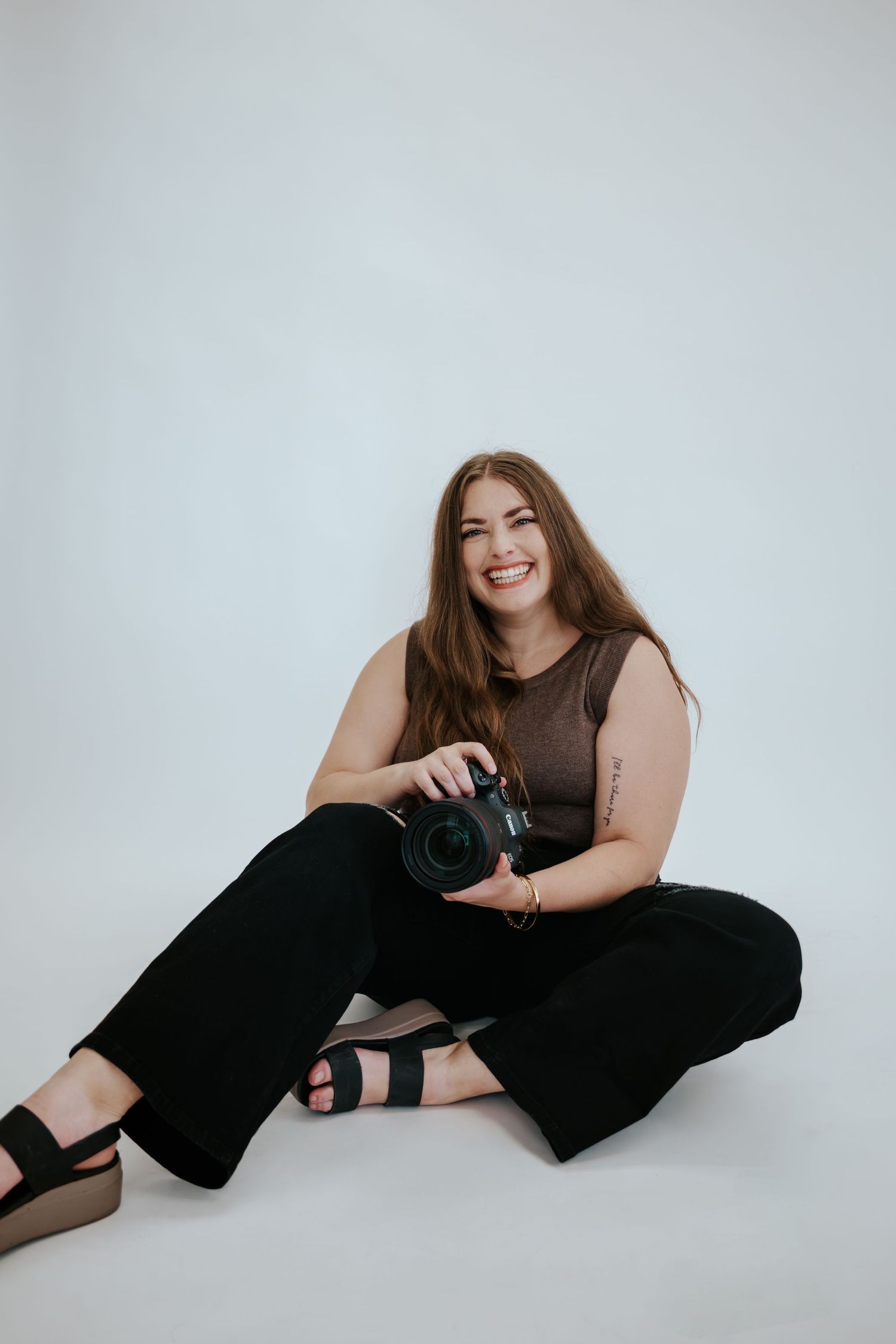 San Francisco Elopement Photographer - photographer in Big Sur holding a camera and laughing