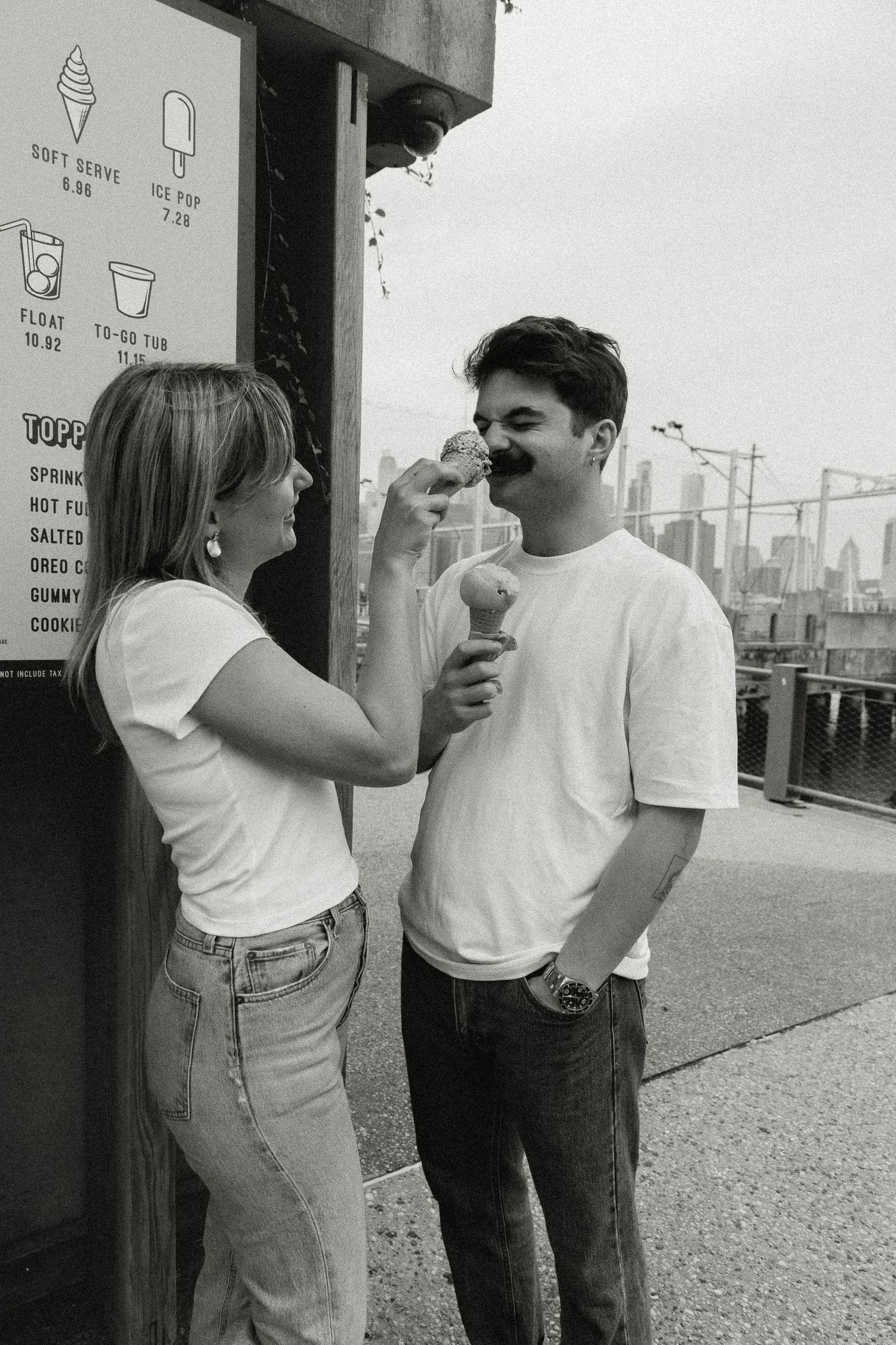 Engaged Couple woman playfully touching a man's nose while he holds an ice cream cone. Brooklyn New York Miranda Photo & Co