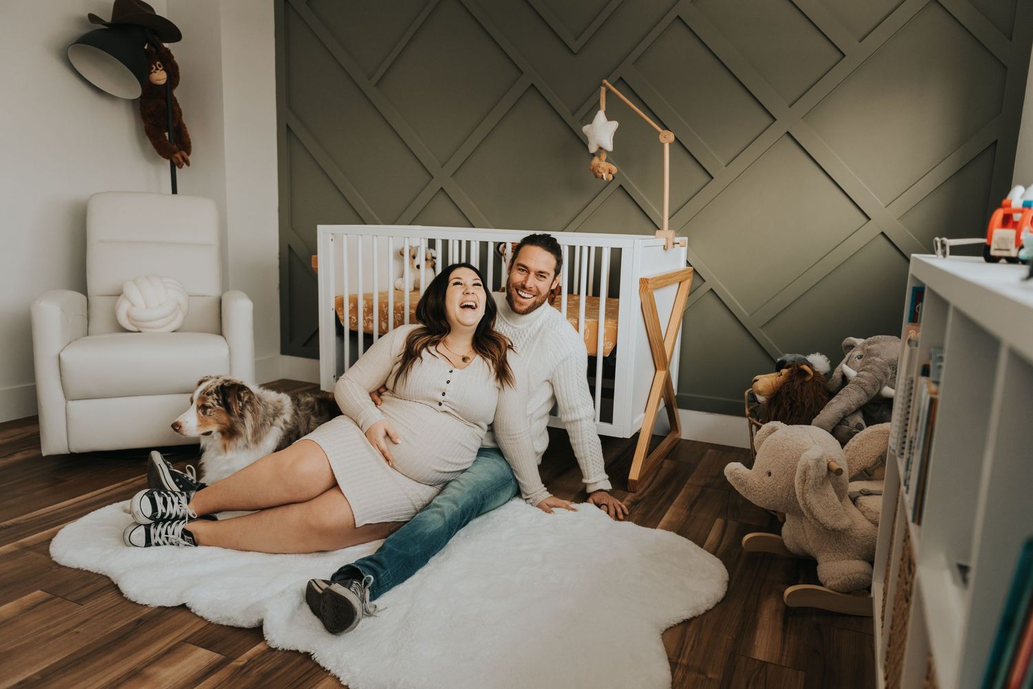 A lifestyle photoshoot in a cozy living room features relaxed poses on a light colored couch near large windows.