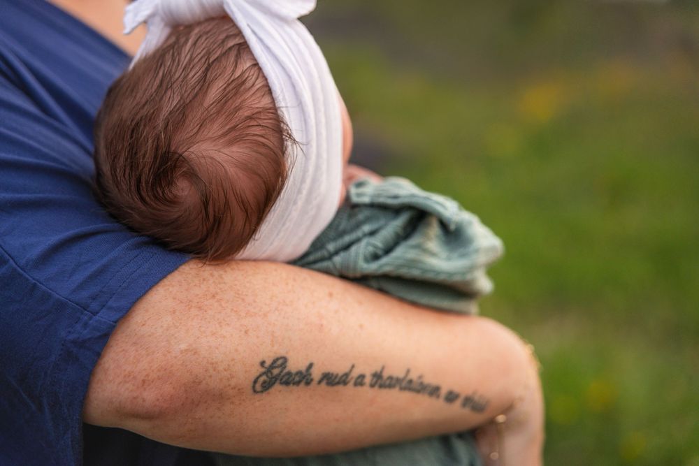 Close up of baby's head in Dad's arms.