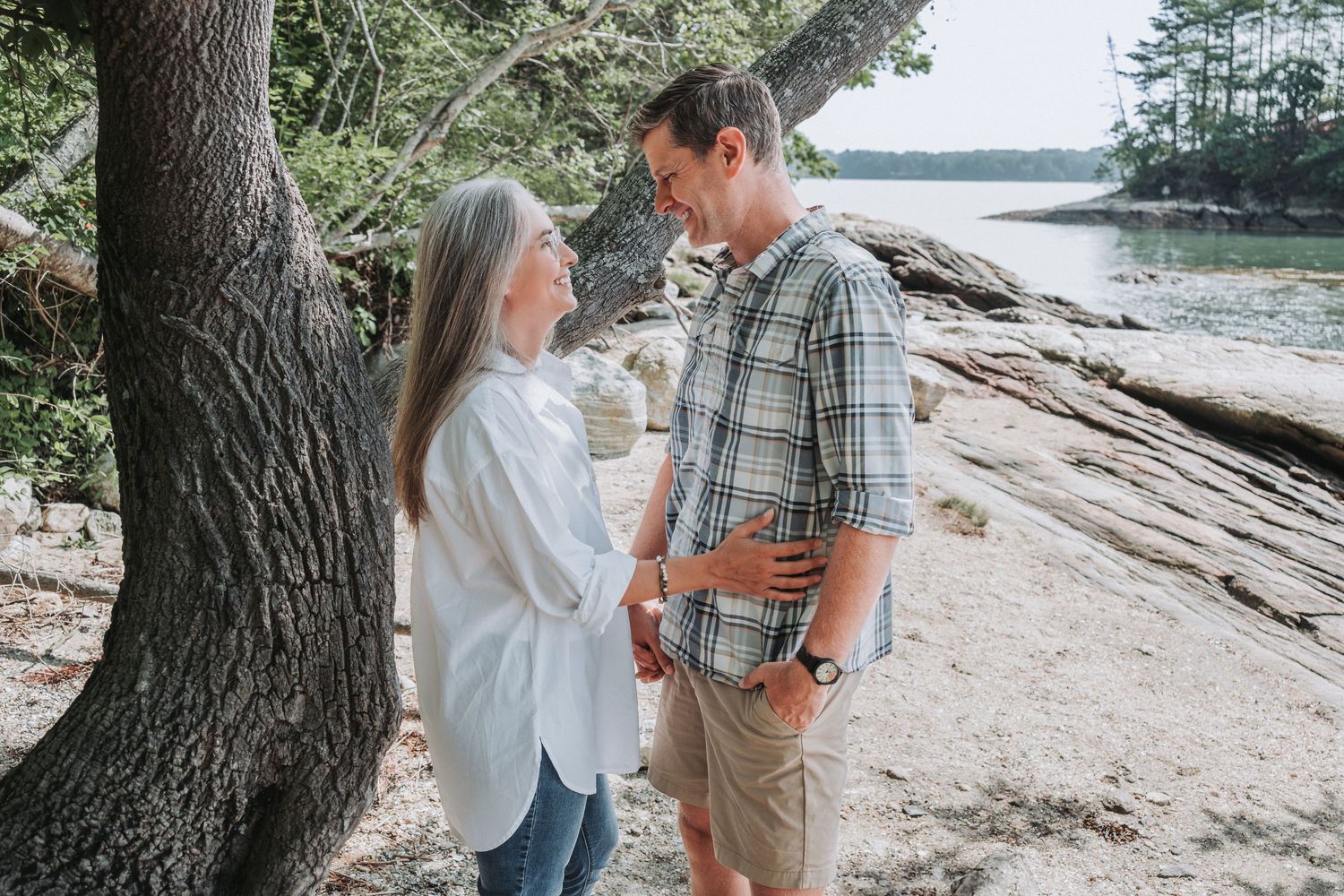 A beautiful couple embraces after their engagement at Simpson's Point in Brunswick, Maine.