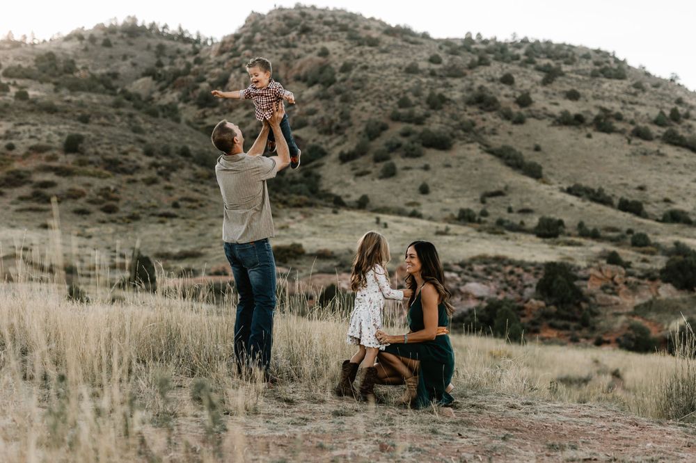 A family enjoying outdoor moments together in a mountainous desert landscape.