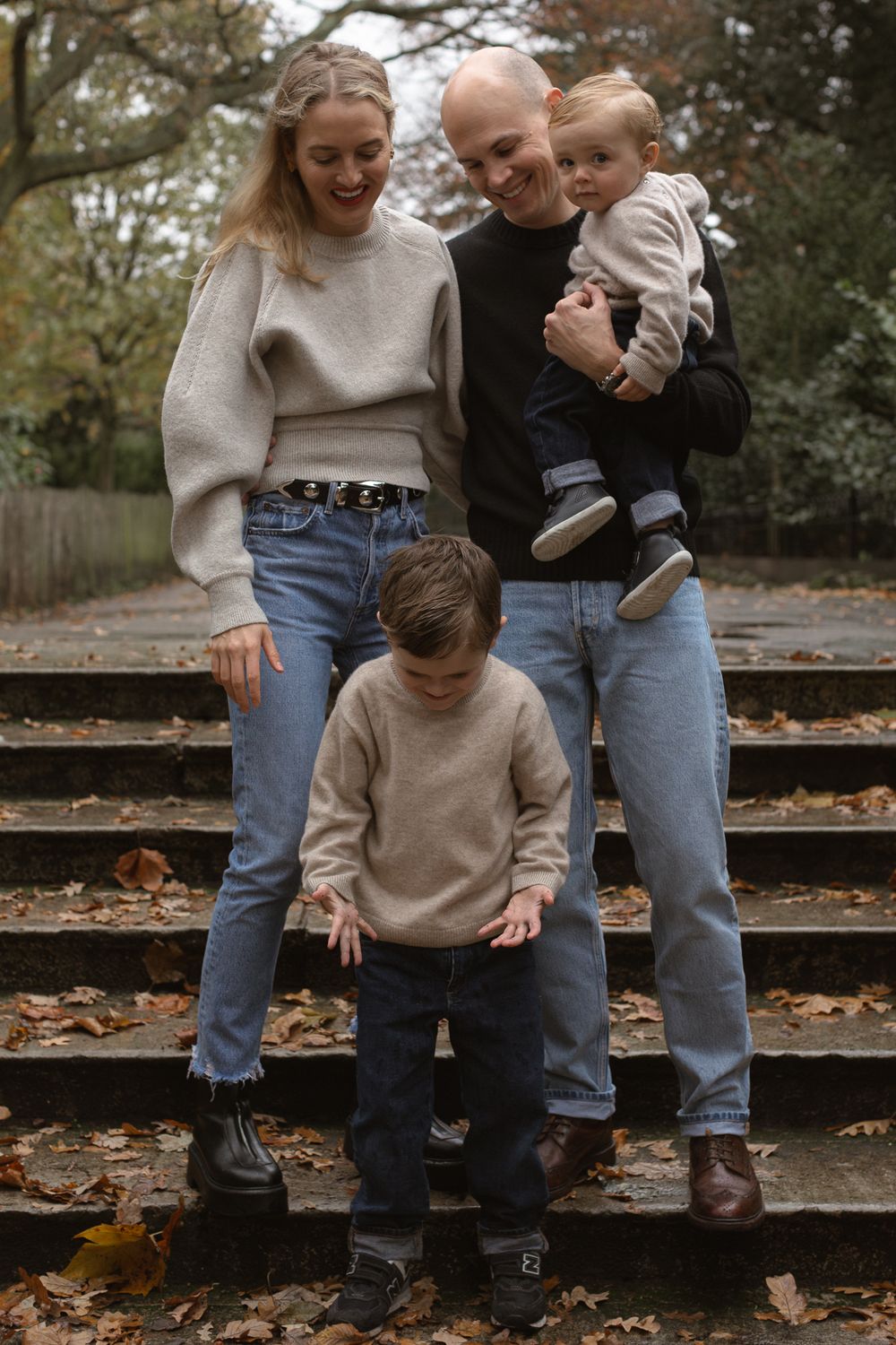 London, UK, family photography session in the park. Family sharing a joyful moment together in Autumn.