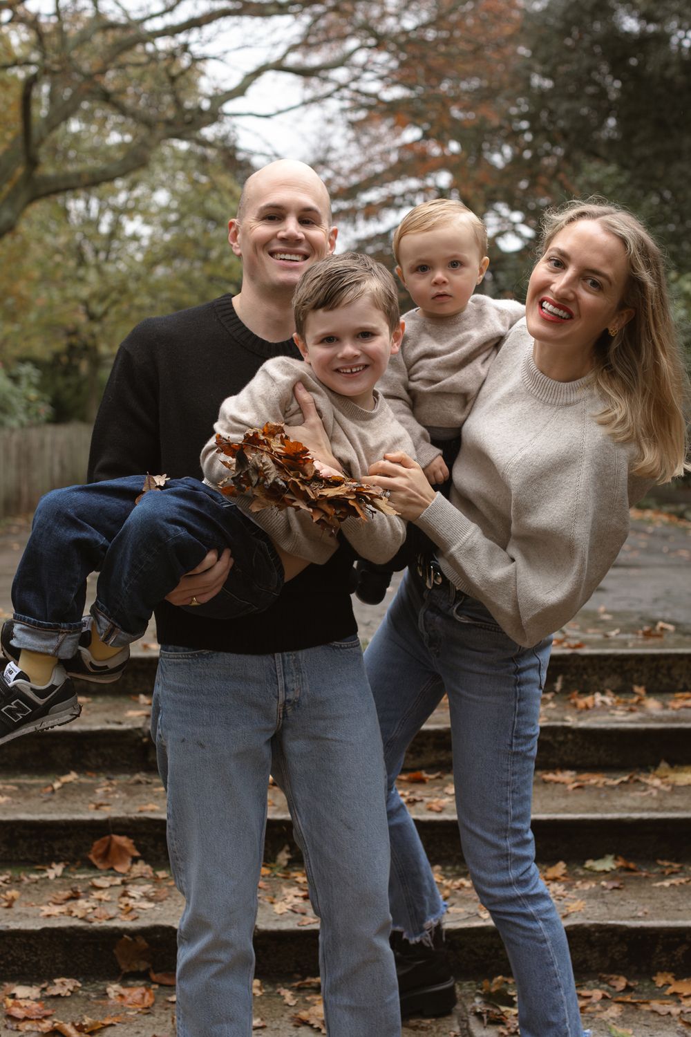 London, UK, family photography session in the park. Family sharing a joyful moment together in Autumn.