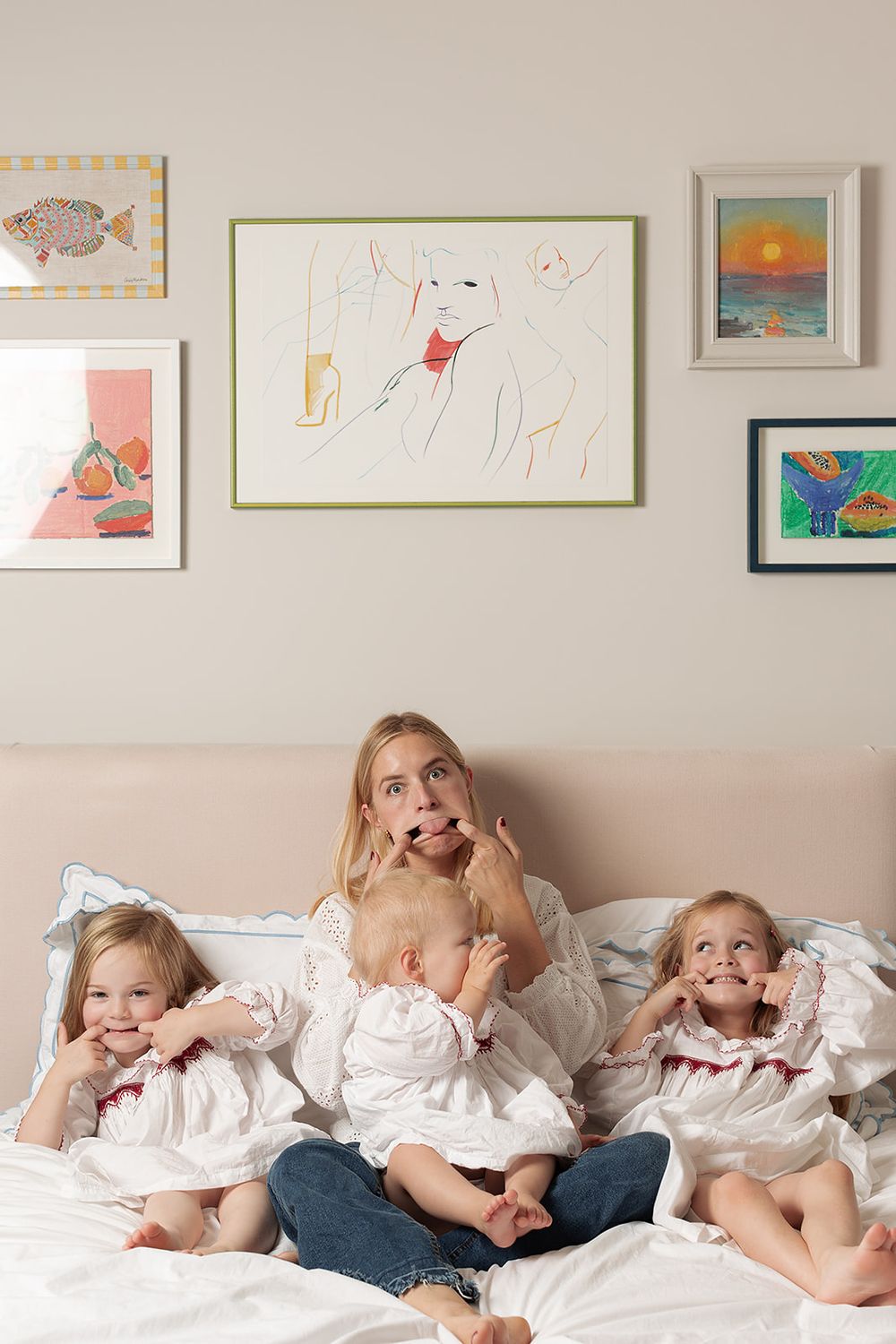 London, UK, motherhood photography session. Sisters wearing matching Smock London night dresses. Mum and her daughters making silly faces.