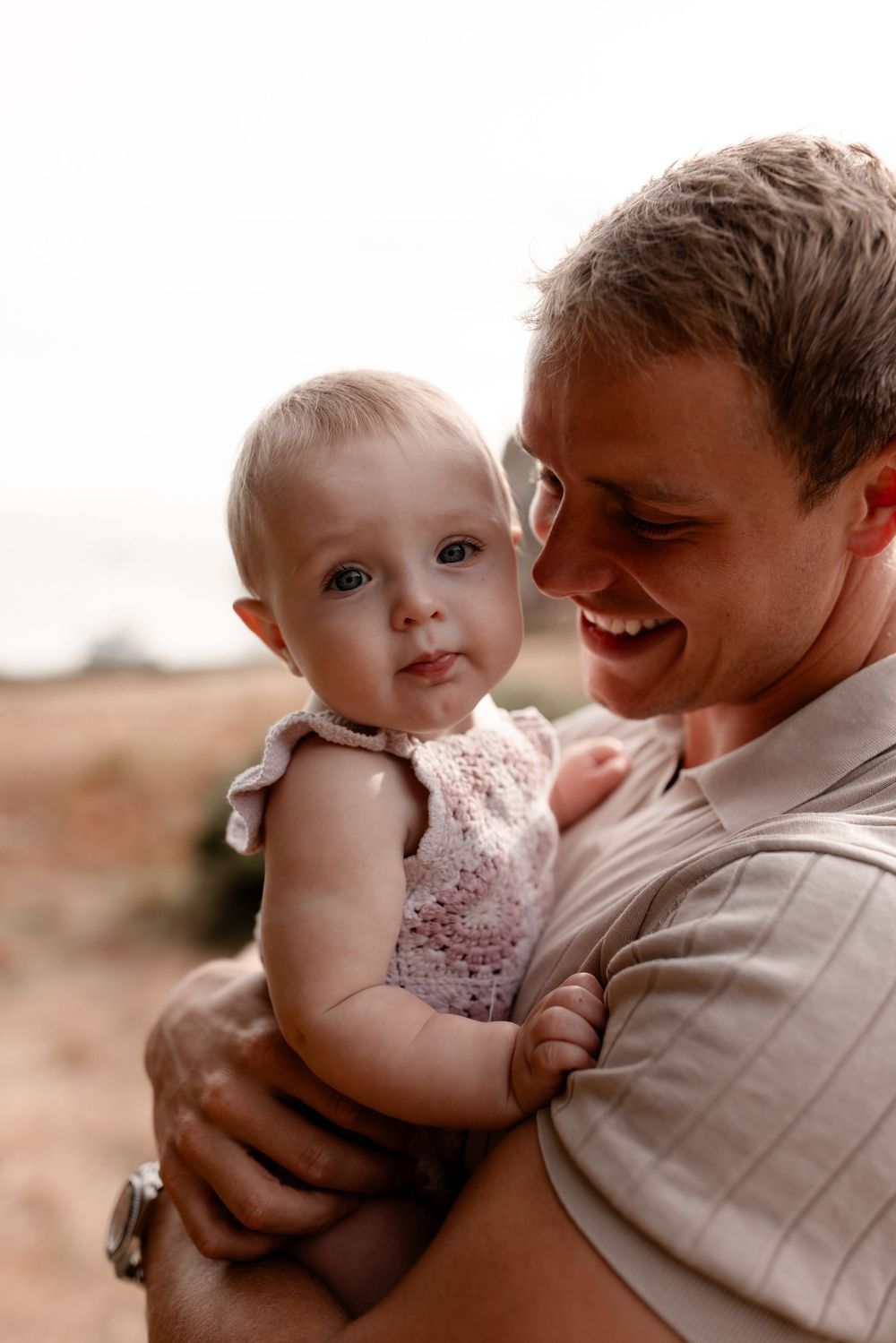 Close-up portrait of tender family interaction in warm lighting.