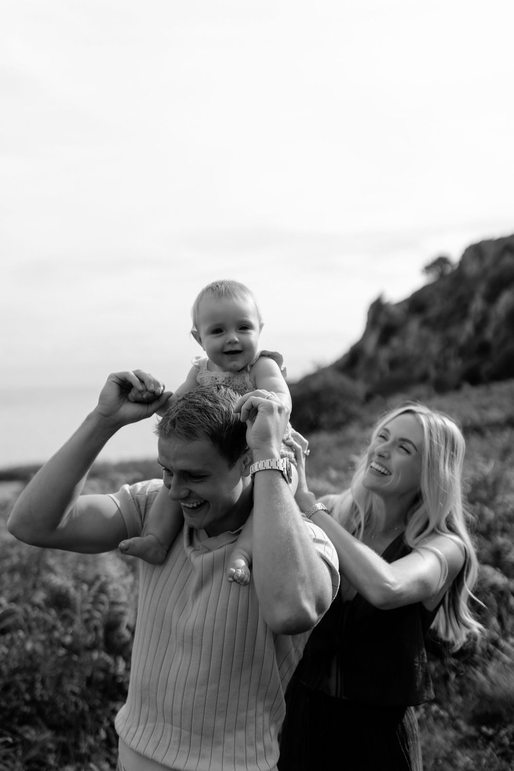Black and white photo captures genuine laughter and joy during an outdoor family session.