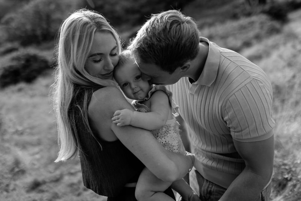 Intimate family portraits show genuine connection during outdoor photography session.
