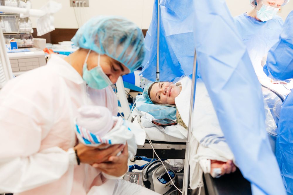 Medical team in protective gear performing surgery in an operating room.
