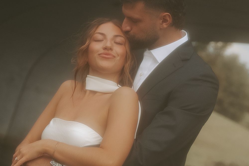 A romantic couple shares an intimate moment in soft, dreamy lighting.