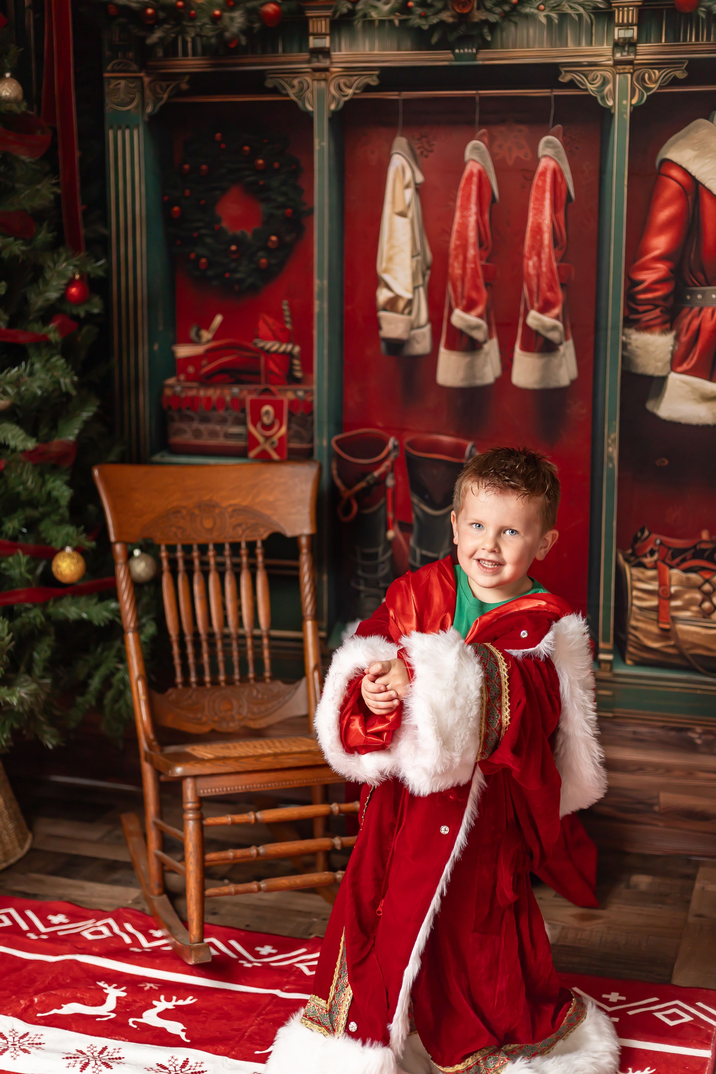 Christmas-themed photo session with red and white decor, wooden chairs, and festive holiday backdrop.
