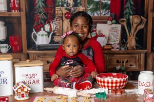 Cheerful holiday baking scene with Christmas decorations and festive red accents.
