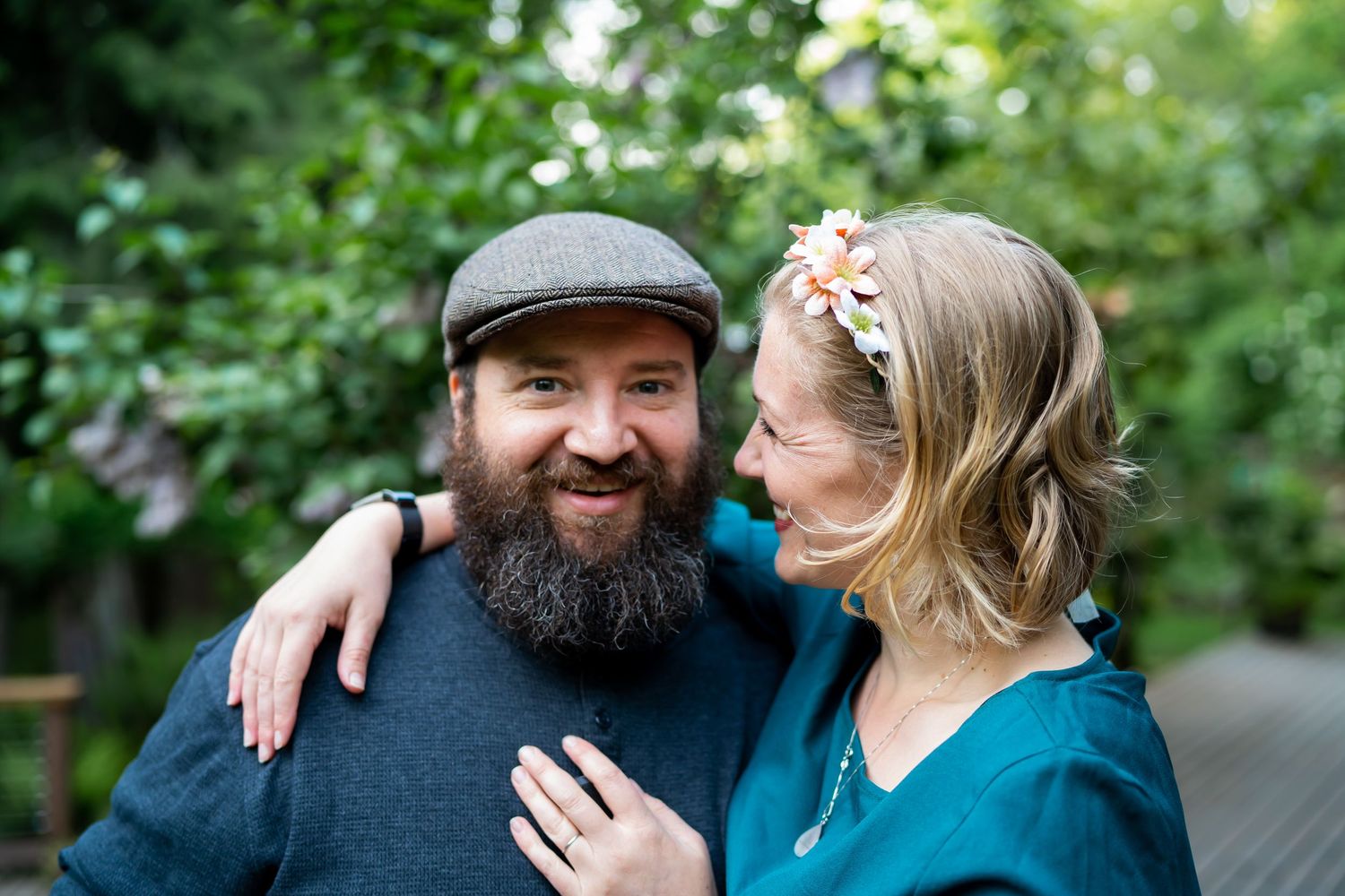 Couple sharing tender moments outdoors during a fall engagement photo session.