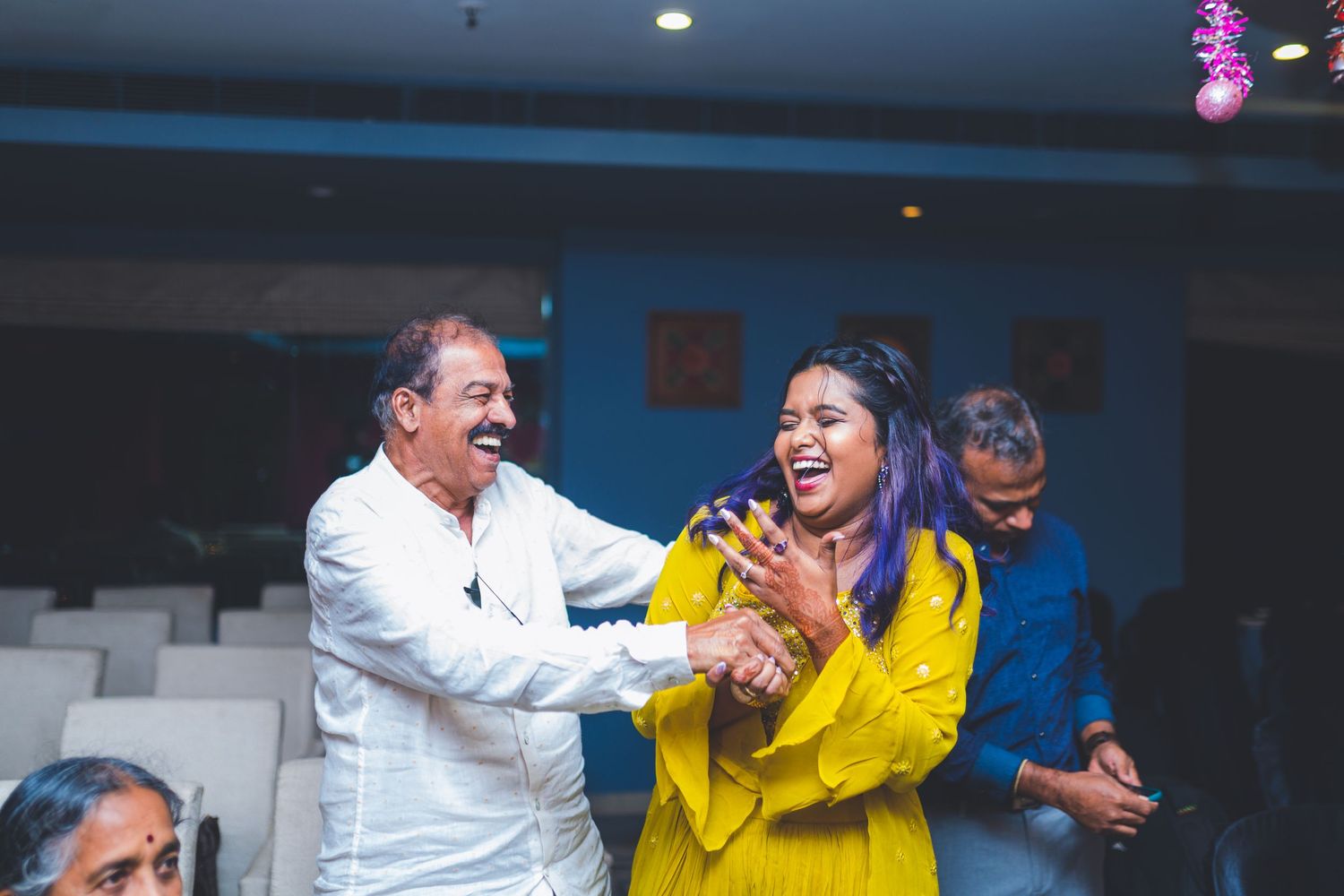 Lively dance moment captured between guests at formal indoor celebration.