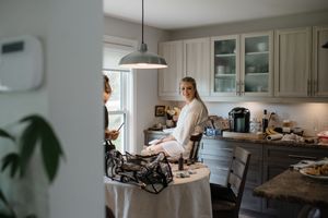 Morning wedding preparations in a bright modern kitchen with catering setup.
