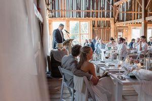 Sequence of wedding photos showing people dancing and celebrating in an elegant rustic barn reception venue.