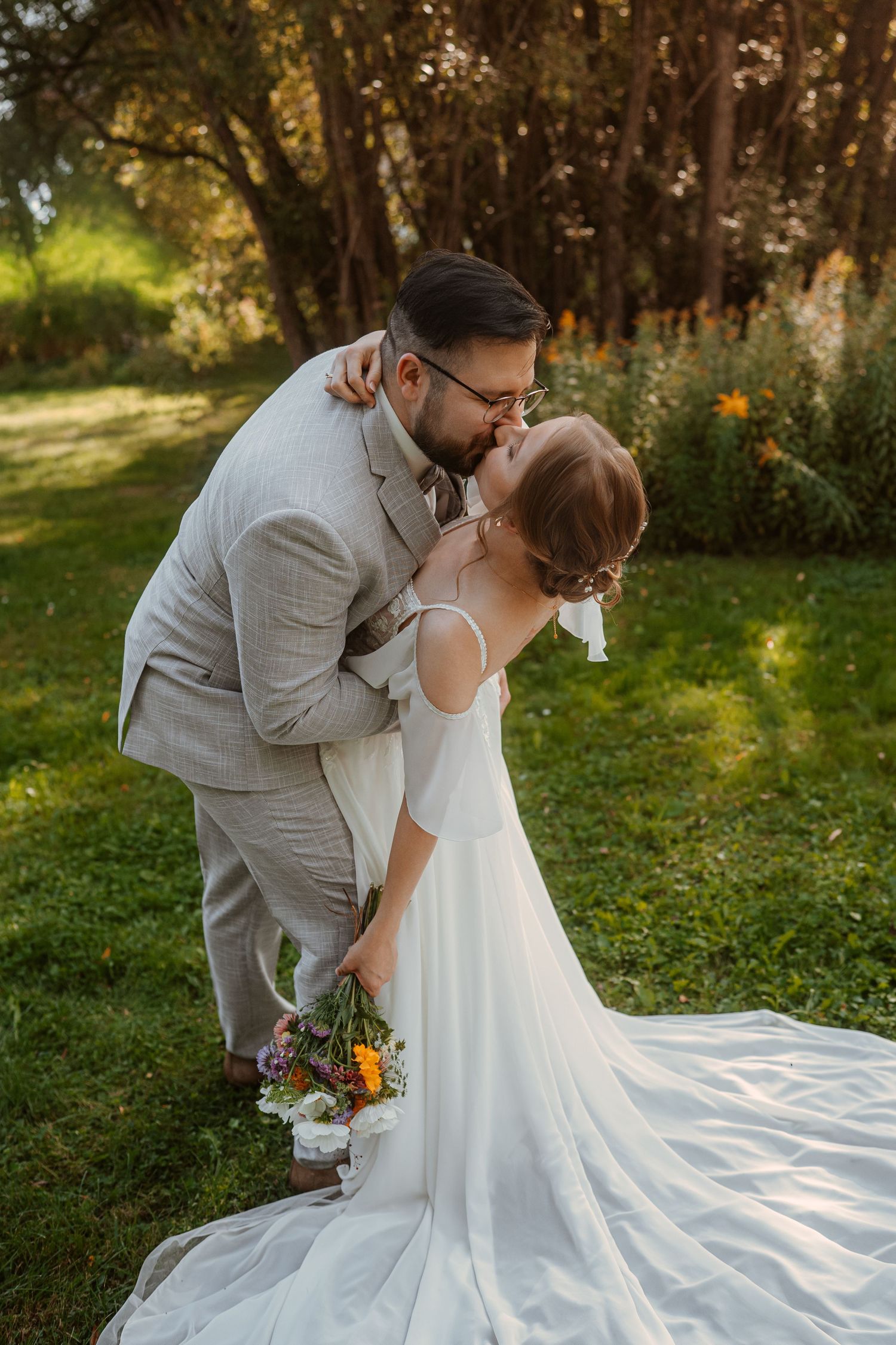 Intimate romantic couple sharing tender kisses in moody lighting with warm orange glow.