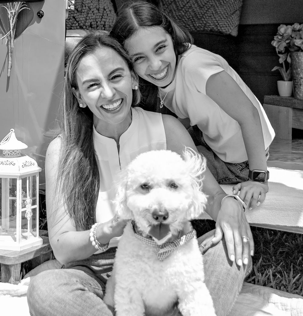 White dog pose with their owners in black and white photography.