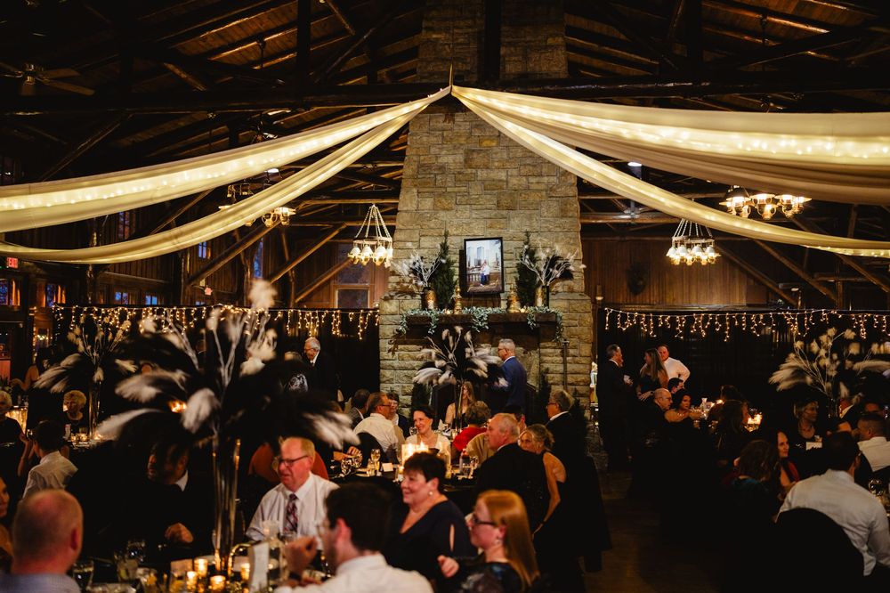 Large indoor venue with draped fabric ceiling and ambient lighting for an elegant celebration.