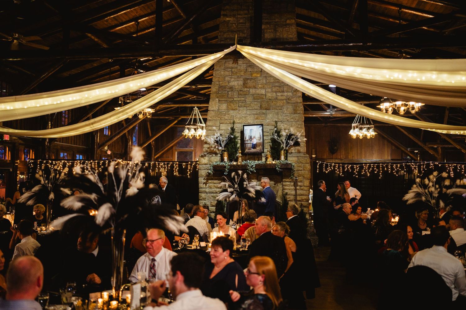 Large indoor venue with draped fabric ceiling and ambient lighting for an elegant celebration.